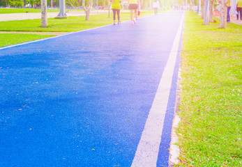 Obraz premium running track in runner rubber cover blue public park. for jogging exercise health, select focus with shallow depth of field
