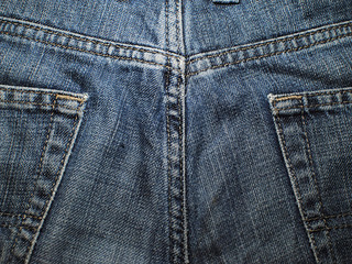 Fototapeta premium Old faded blue jeans. Macro. Pocket on old blue jeans.