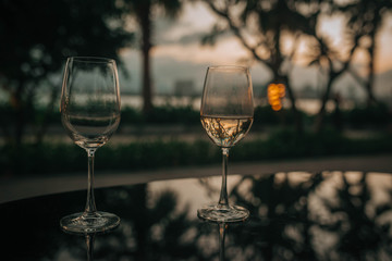 glasses of wine on the table against the background of sunset in Vietnam