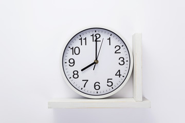 wall clock at shelf on white background