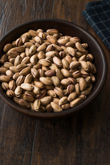 Pistachio Nuts with Shell in Wooden Bowl.