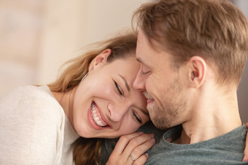 Close up - portrait of happy newlyweds charming positive girl and nice guy enjoying chatting with each other during honeymoon