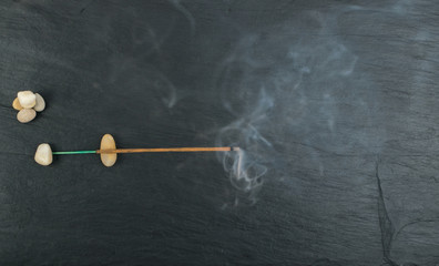 Burning incense aroma sticks with smoke on black background