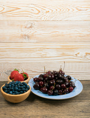 Fresh Summer Berries on Rustic Wooden Background