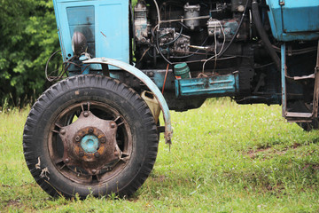 Fototapeta na wymiar Old tractor wheel and engine