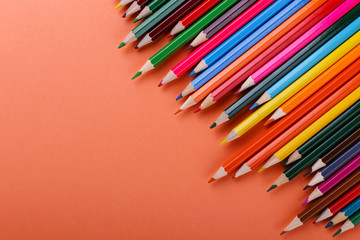 Colored pencils, school supplies for drawing, pattern, copy space.