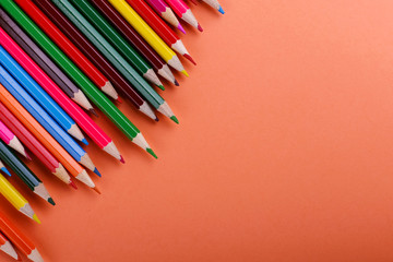 Colored pencils, school supplies for drawing, pattern, copy space.