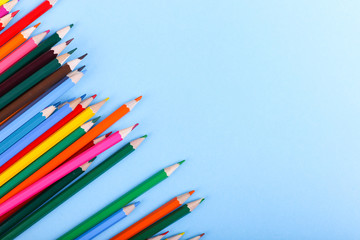 Colored pencils, school supplies for drawing, pattern, copy space.