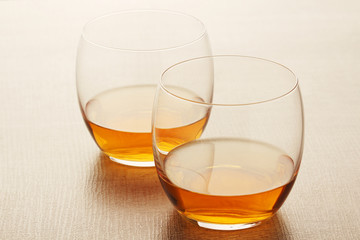 Two glasses with whiskey without ice cubes
