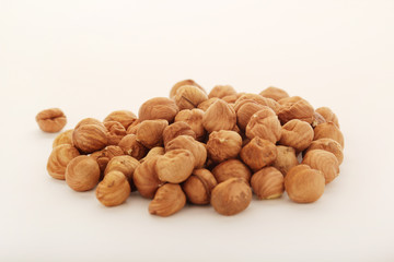 A pile of hazelnuts at white background