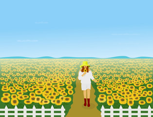 Women in a white dress wearing a hat are walking in the sunflower field. There is a white fence around and there is a mountain in the background.