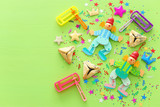 Purim celebration concept (jewish carnival holiday) over wooden green background. top view, flat lay