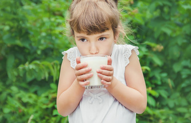 The child drinks milk and cookies. Selective focus.