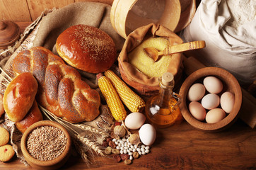Baked goods, eggs, corn on a wooden table