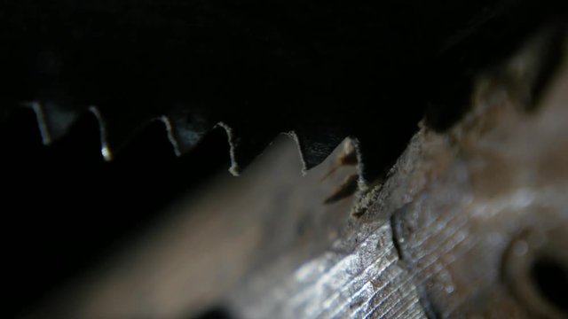 macro of sawing wood with a hacksaw in the workshop