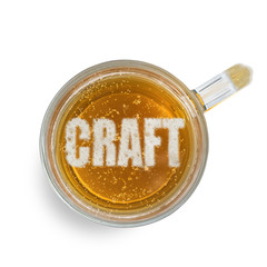 Inscription craft on the beer foam in glass isolated on white background. Top view