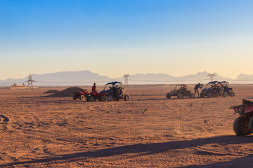 Fototapeta na wymiar Safari trip through egyptian desert driving buggy cars