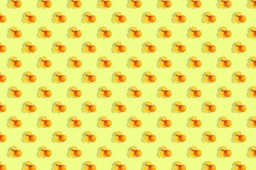 Oranges on bright colored yellow background. Repeating pattern, preparation for wallpaper citrus mood.