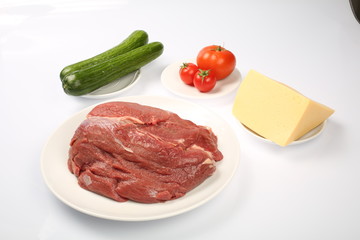cheeseburger, chicken cutlet, bacon, tomatoes and slices of cheese, dressed with sauce and green salad for a restaurant menu on a white isolated background