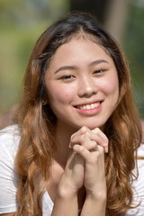 A Praying Asian Female