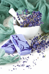 Homemade soap with lavender flowers on  wooden board