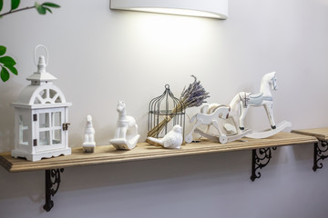 interior decoration toys. White decorative wooden latern lights and ceramic horses in expensive interior