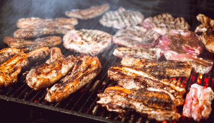 Roasted Juicy meat cooked over the coals on a barbecue in night