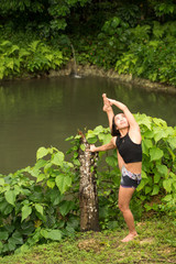 Filipino girl yoga posing in tropical jungle rice fields