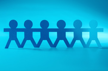 group of paper people holding hands