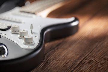 closeup of a guitar on wooden table