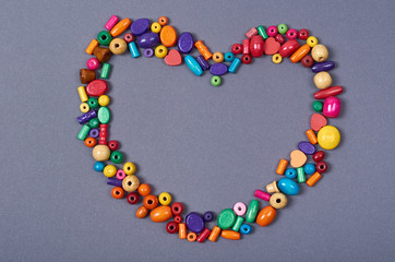 Wooden color beads composition. Needlework concept background. Flat lay