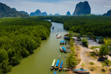 Aerial view of colorful traditional Longtail boats at a small pier in a mangrove forest (Phang Nga Bay)