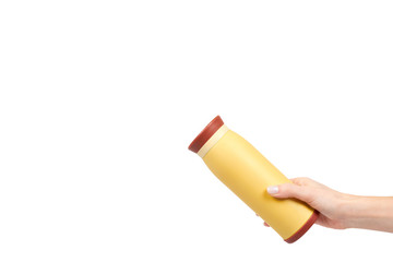 Yellow metal thermos for hot drinks, travel concept