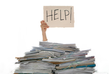 Person under a pile of papers with a hand holding a sign of help. Accounting.