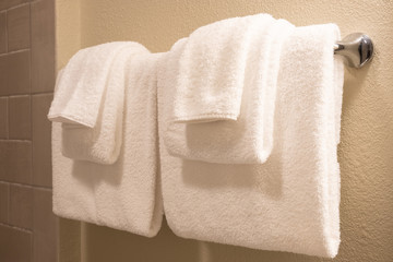 Clean white towel on a hanger prepared to use.