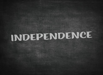 independence concept word on a blackboard background