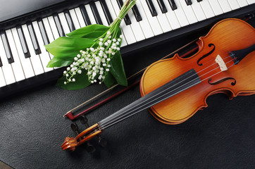 Keyboard synthesizer, violin and a bouquet of flowers