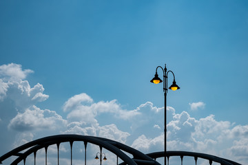 yellow lighting street poles over the bridge