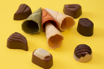 colorful ice cream cones on yellow background