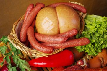 Sausages and vegetables on a wooden tray.