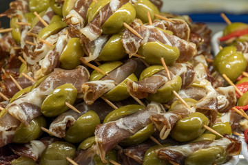 Close up, skewer of olives with garnish