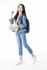 Beautiful young woman smiling and pulling pink colour luggage isolated on white background.Asian woman going to summer vacation.Travel trip funny.