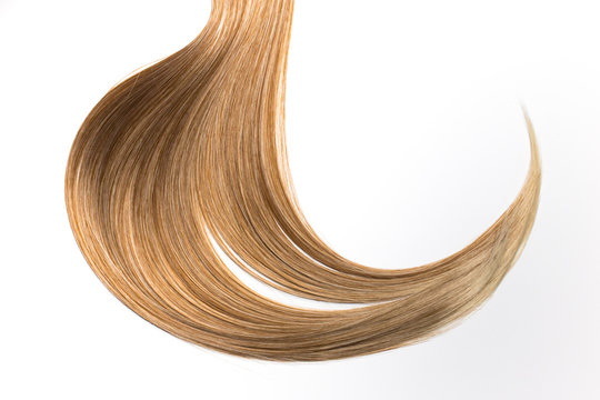 Piece of beautiful, shiny blonde hair on white isolated background