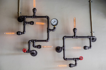 steel pipe and lamp on wall