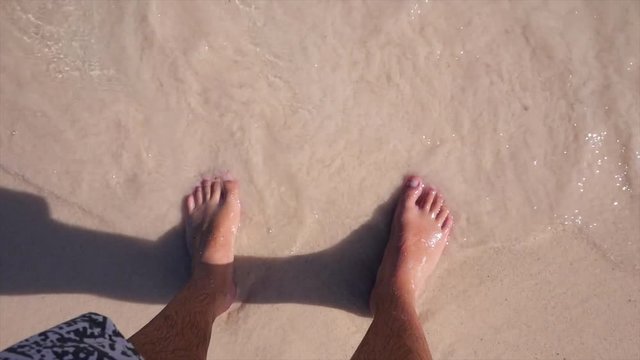Feet in the sand on the beach, Mexico