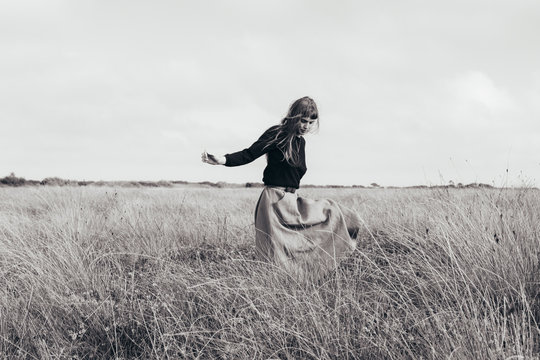 Woman walking alone in meadow