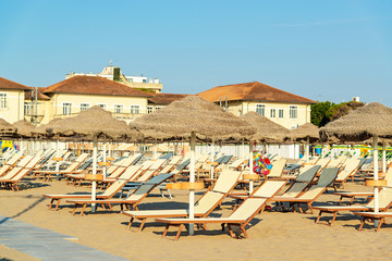 Umbrellas and chaise lounges on the beach of Rimini in Italy...