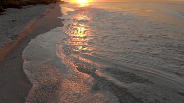Amazing Close Up Aerial Waves On Shore Tilt Up Sunrise
