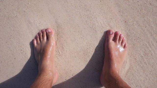 Feet in the sand on the beach, Mexico