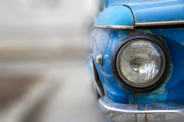 Shiny blue vintage car. Detail view of the headlight. Retro car. Front light. Retro automobile...